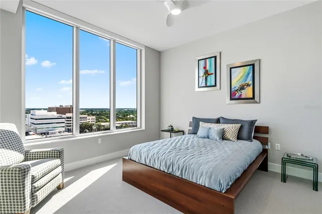 a bedroom with a large bed and a lamp next to a window