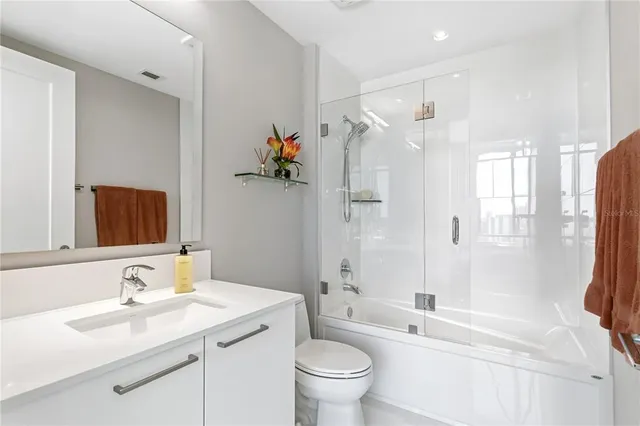 a bathroom with a sink toilet tub and shower