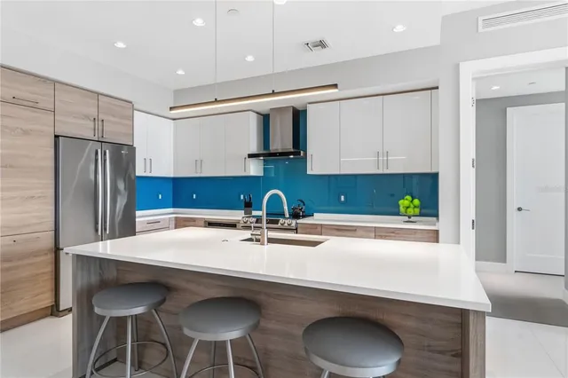a kitchen with stainless steel appliances a sink and a refrigerator