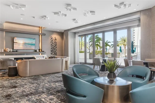 a living room with a large window and furniture