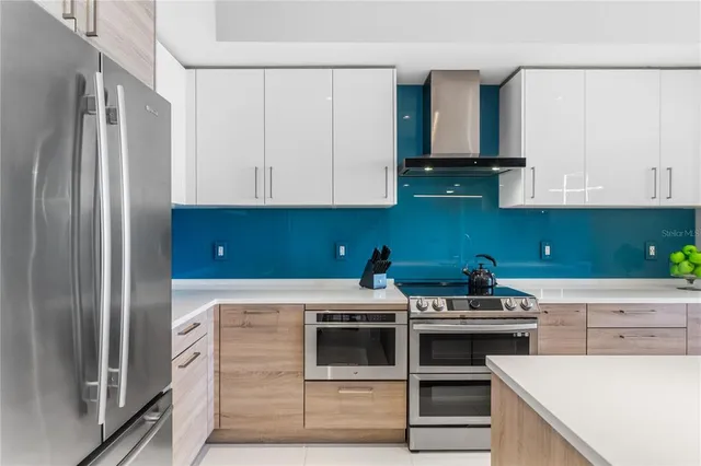 a kitchen with a stove and a refrigerator