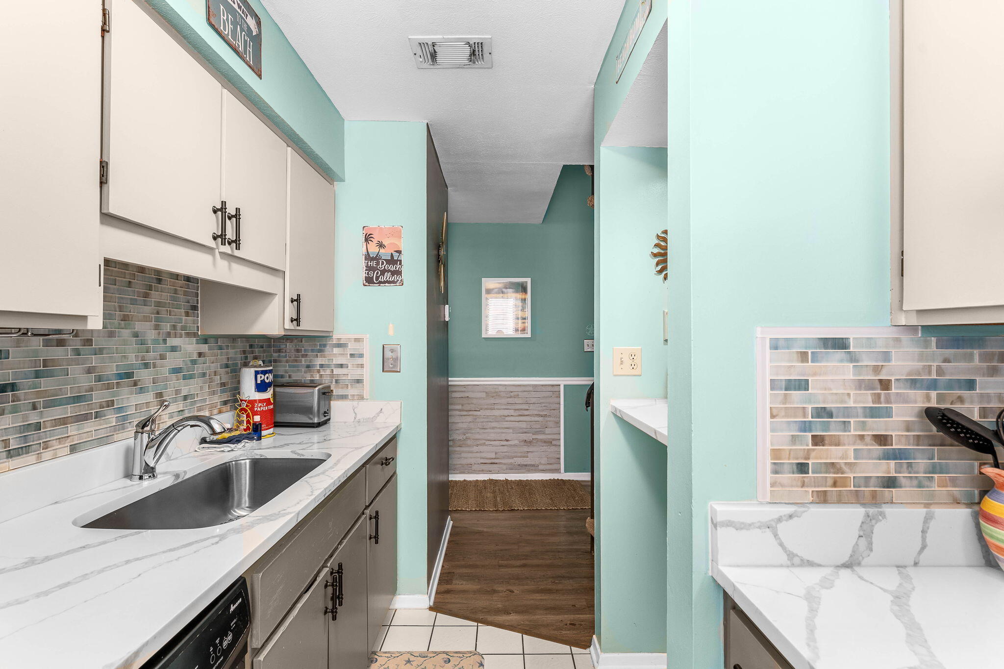 17614 Front Beach Road, Unit D13 Panama City Beach, FL 32413 - Photo 16 of 46 a kitchen with stainless steel appliances a sink stove and cabinets