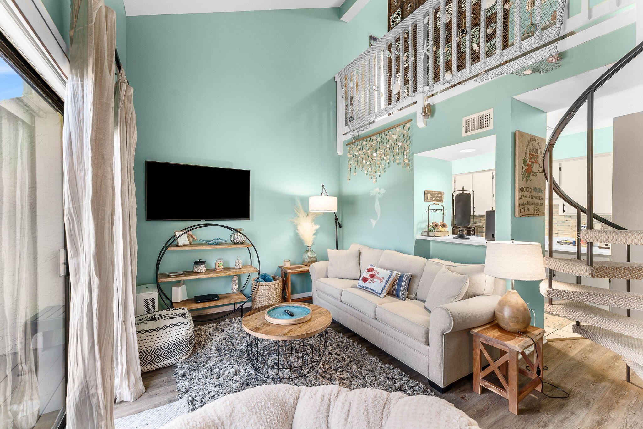 17614 Front Beach Road, Unit D13 Panama City Beach, FL 32413 - Photo 19 of 46 a living room with furniture a flat screen tv and a floor to ceiling window