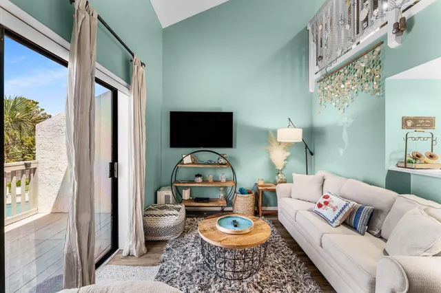 a living room with furniture a rug and a toilet