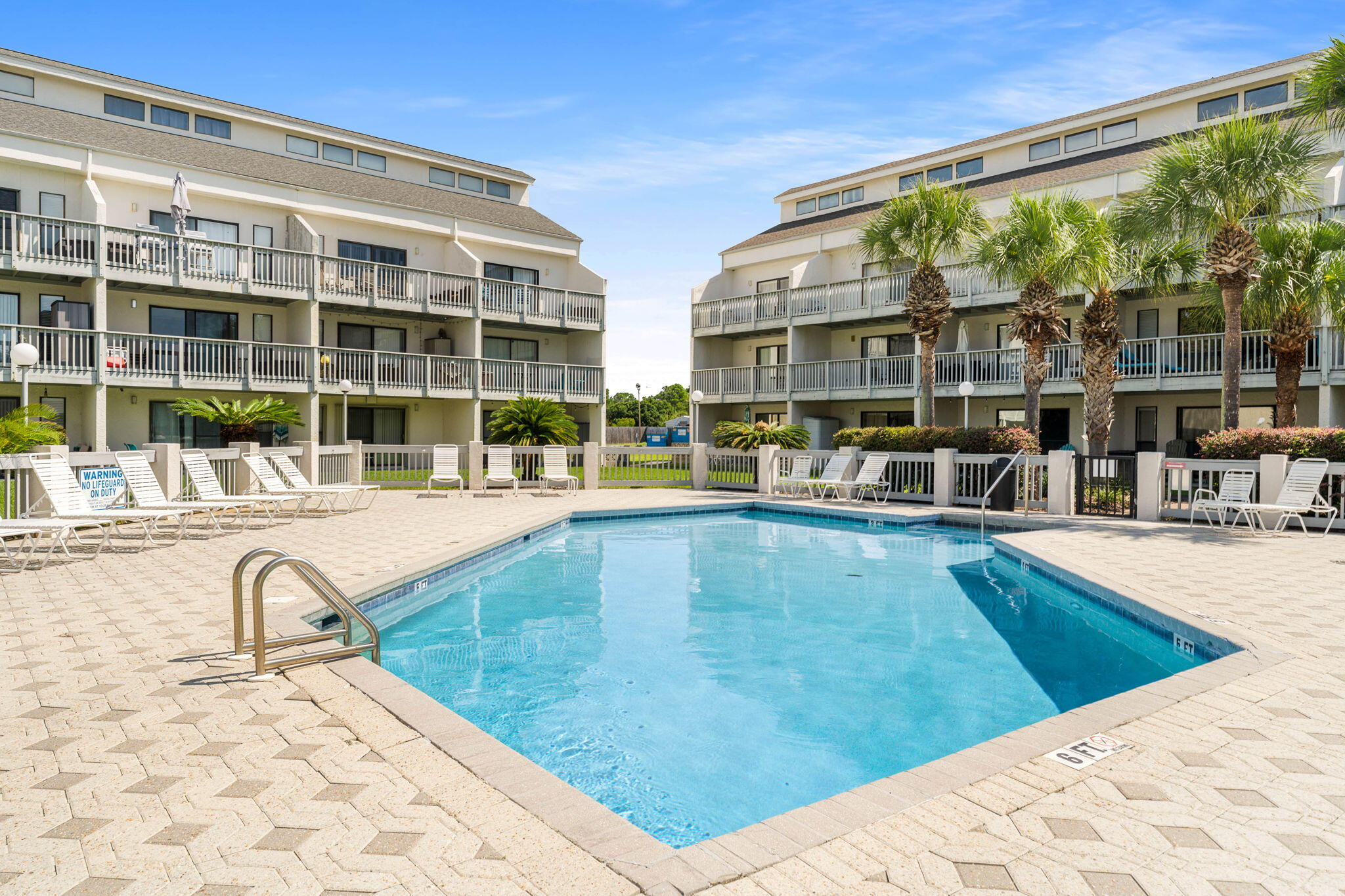 17614 Front Beach Road, Unit D13 Panama City Beach, FL 32413 - Photo 2 of 46 a swimming pool with outdoor seating