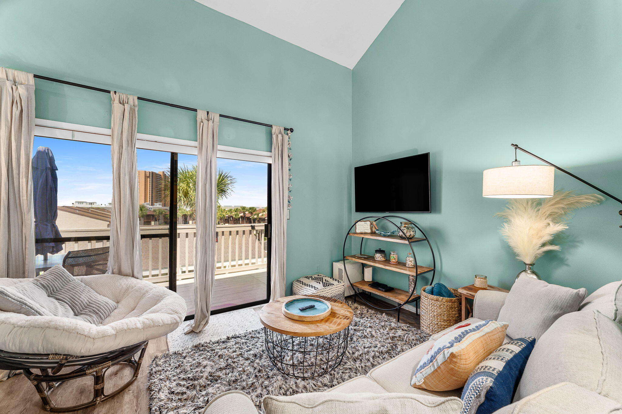 17614 Front Beach Road, Unit D13 Panama City Beach, FL 32413 - Photo 21 of 46 a living room with furniture and a flat screen tv