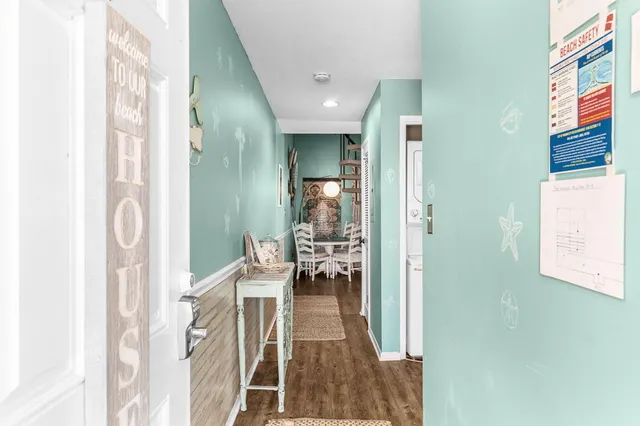 a view of a hallway with dining area and livingroom view