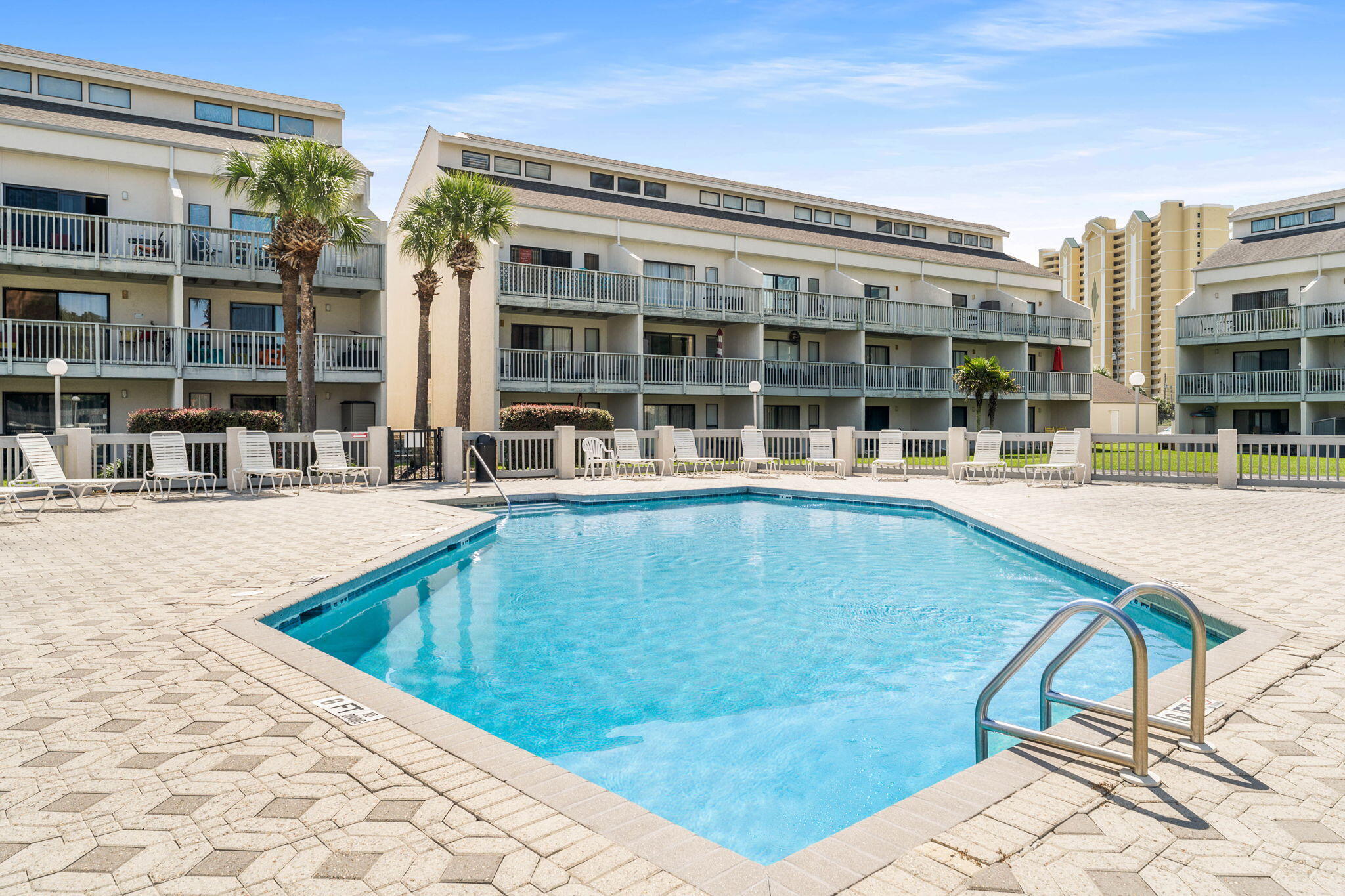 17614 Front Beach Road, Unit D13 Panama City Beach, FL 32413 - Photo 30 of 46 a view of a swimming pool with a lounge chairs