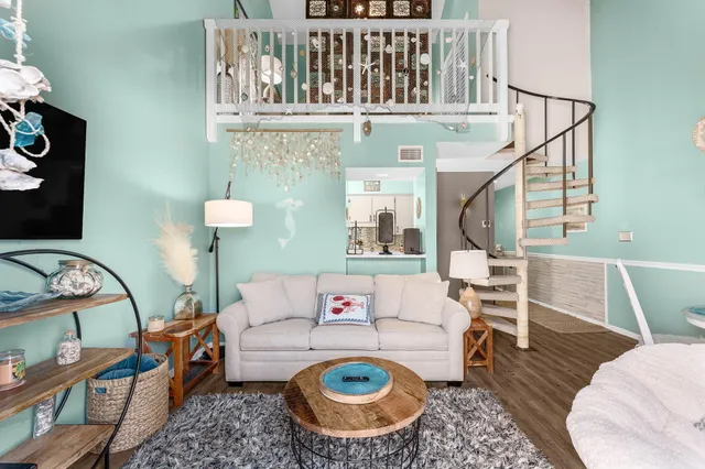 a living room with furniture a rug and a window