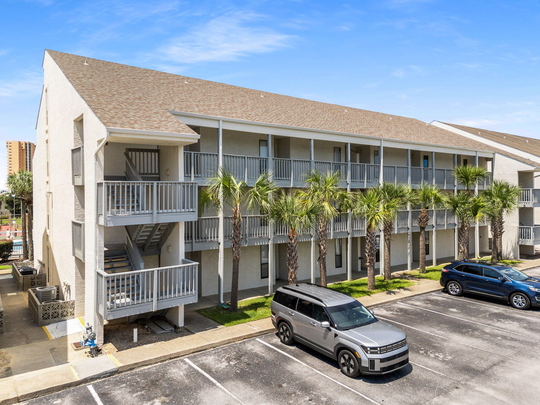 17614 Front Beach Road, Unit D13 Panama City Beach, FL 32413 - Photo 37 of 46 a small garden with a bench in front of house