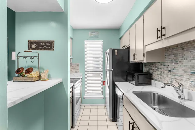 a kitchen with a sink cabinets and utility