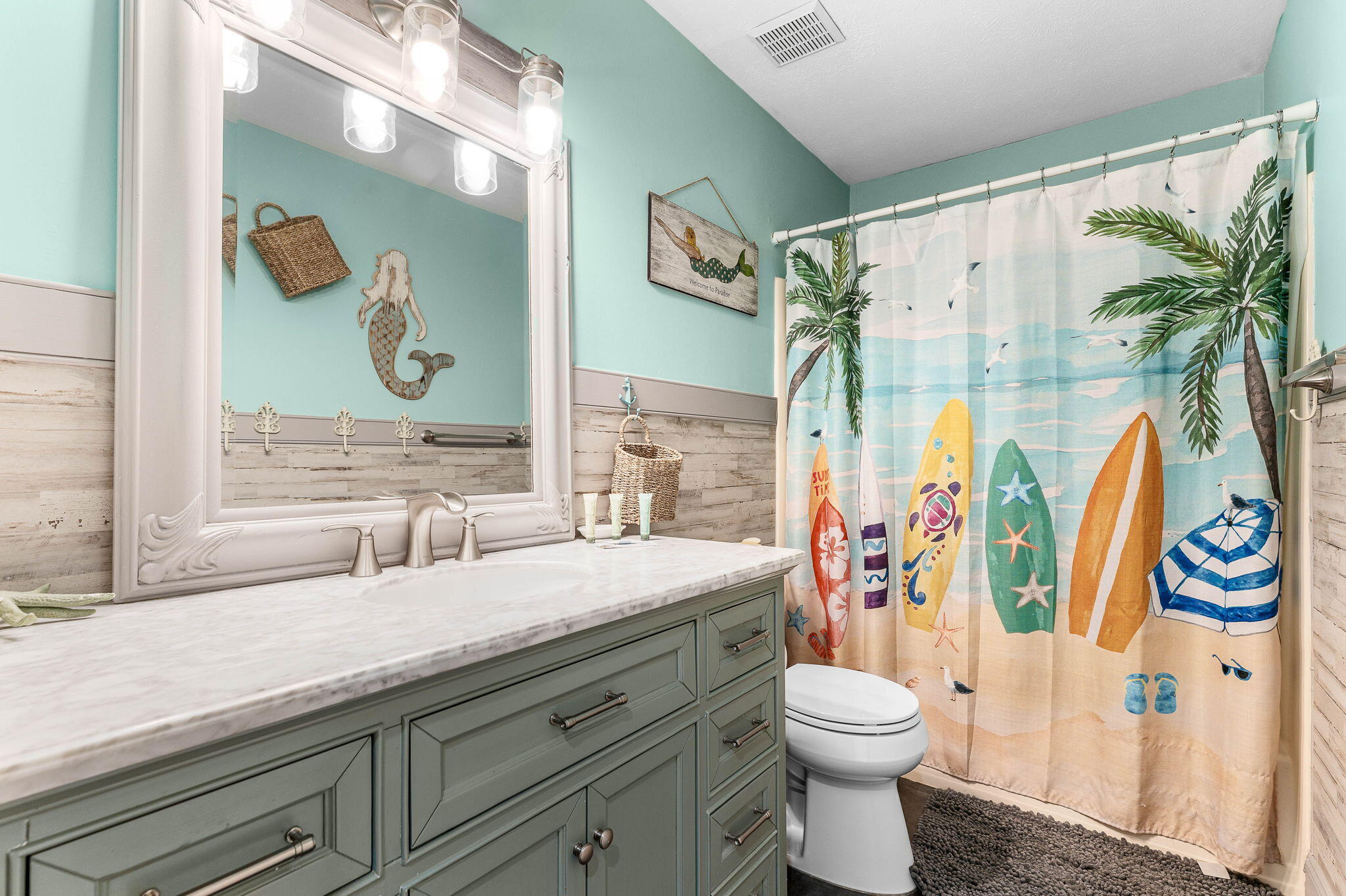 17614 Front Beach Road, Unit D13 Panama City Beach, FL 32413 - Photo 10 of 46 a bathroom with a sink a toilet and shower curtain