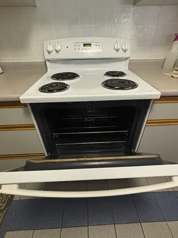 a stove top oven sitting inside of a kitchen