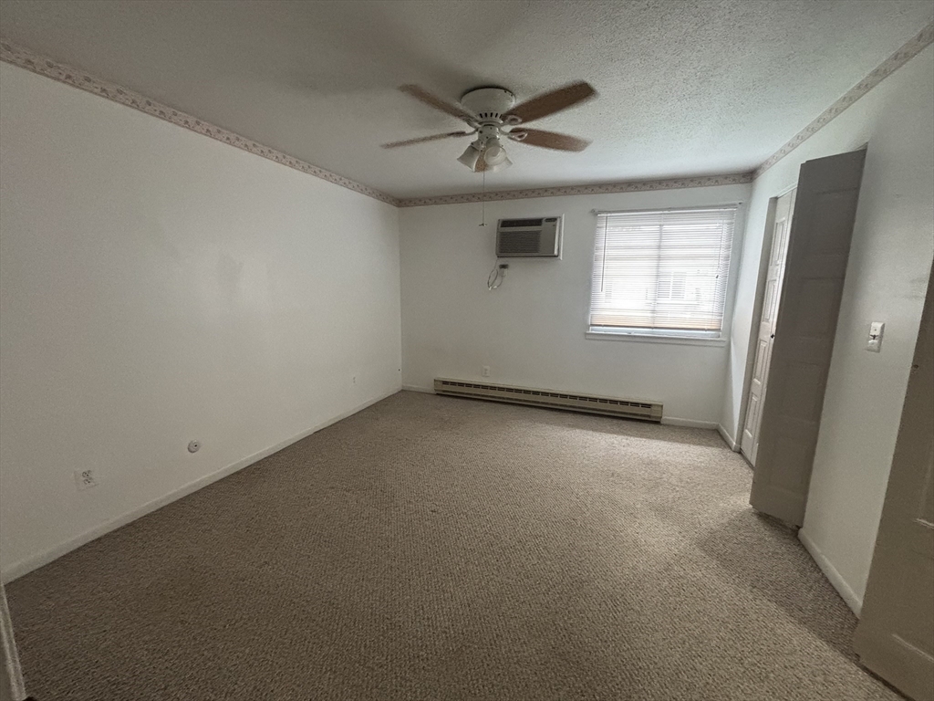 440 North Avenue, Unit 60 Haverhill, MA 01830 - Photo 7 of 9 an empty room with a ceiling fan and windows