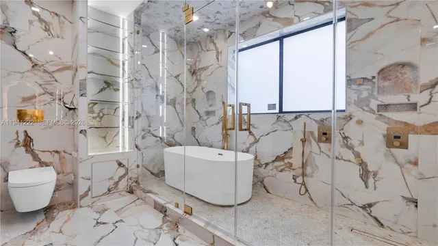 a bathroom with a toilet sink and mirror