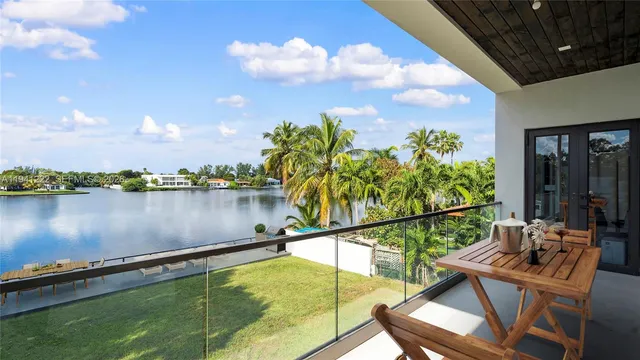 a view of a lake with couches chairs