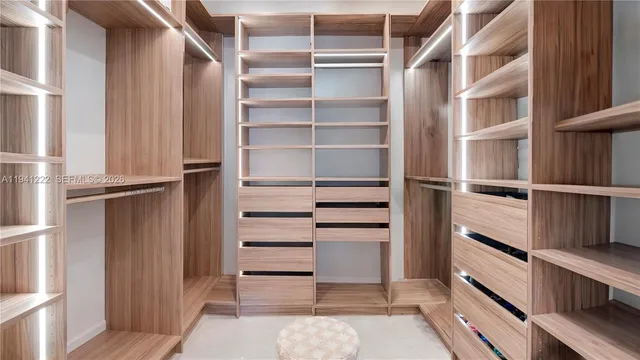 a view of walk in closet with empty racks