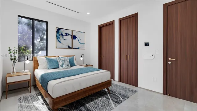 a bedroom with a bed and a painting on the wall