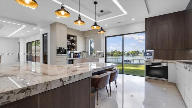 a kitchen with stainless steel appliances granite countertop a sink and a stove