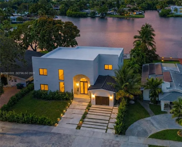a view of a lake with houses in the background