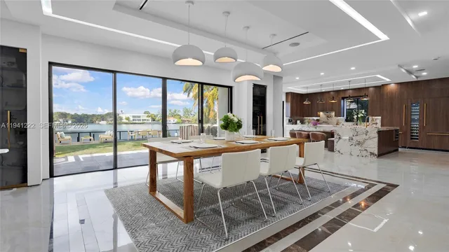 a dining room with furniture a chandelier and wooden floor