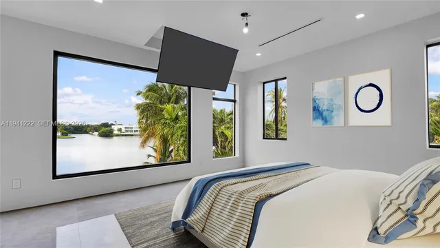 a bedroom with a bed and a large window