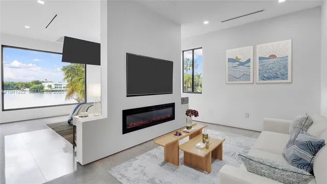 a living room with furniture flat screen tv and a fireplace