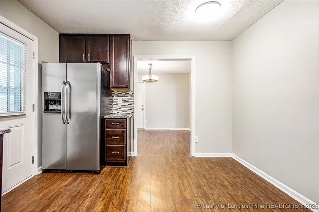a view of kitchen with wooden floor electronic appliances and window