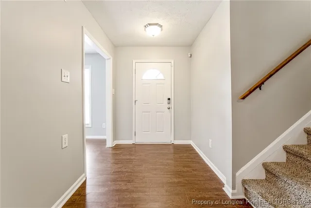a view of a hallway with wooden floor