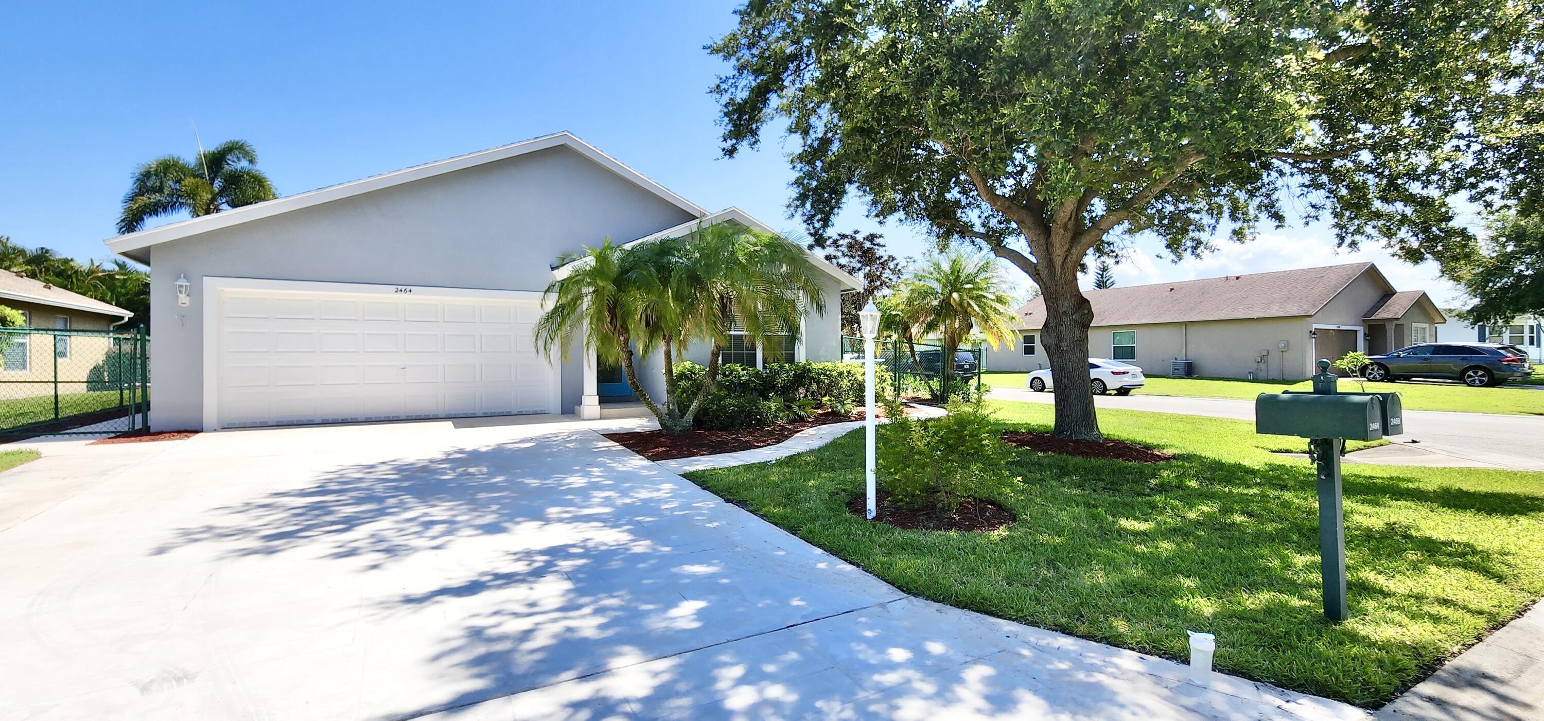 2464 Southwest Omega Way Stuart, FL 34997 - Photo 24 of 70 Front of home on Corner lot