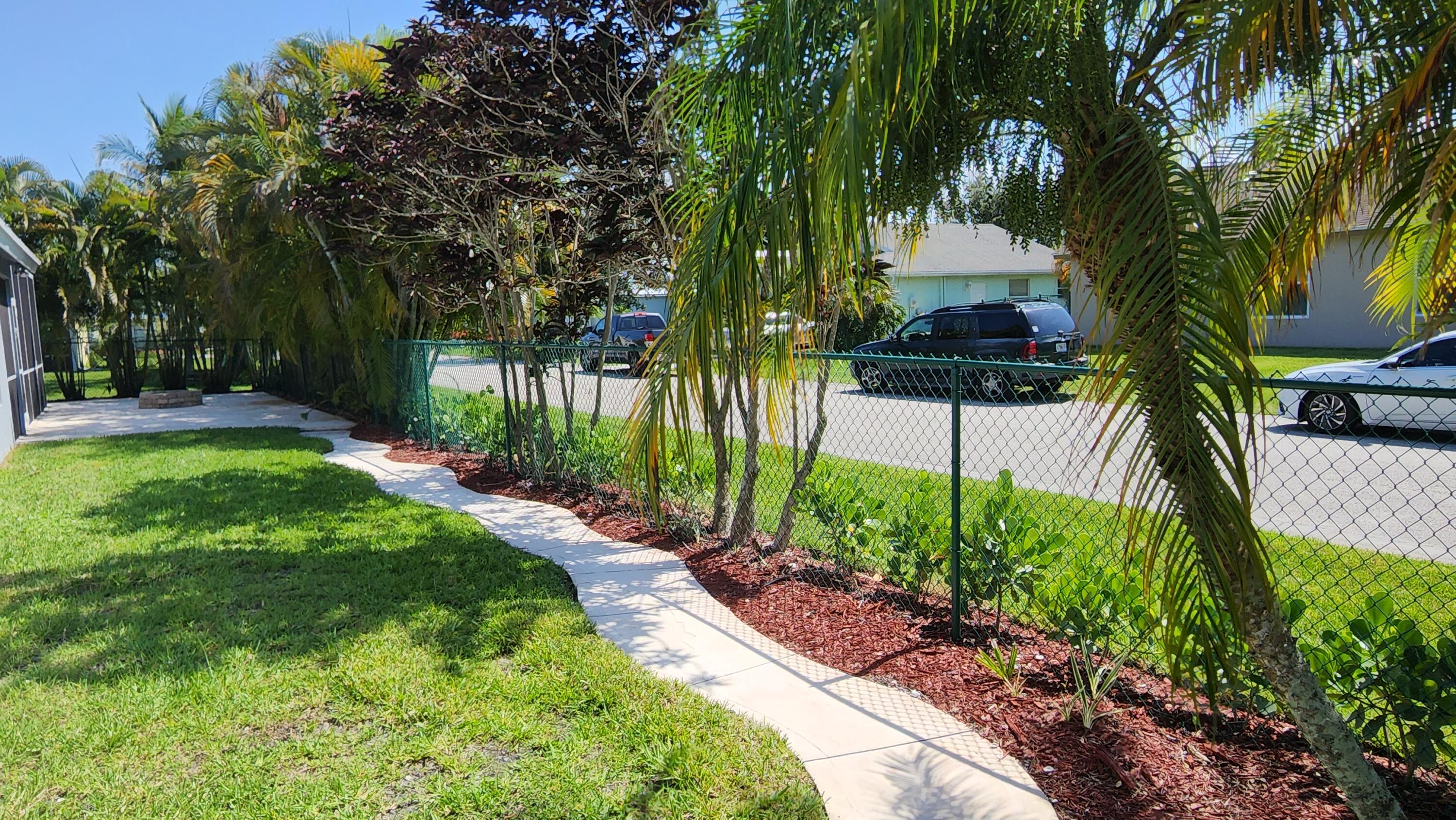 2464 Southwest Omega Way Stuart, FL 34997 - Photo 26 of 70 West yard view from front gate