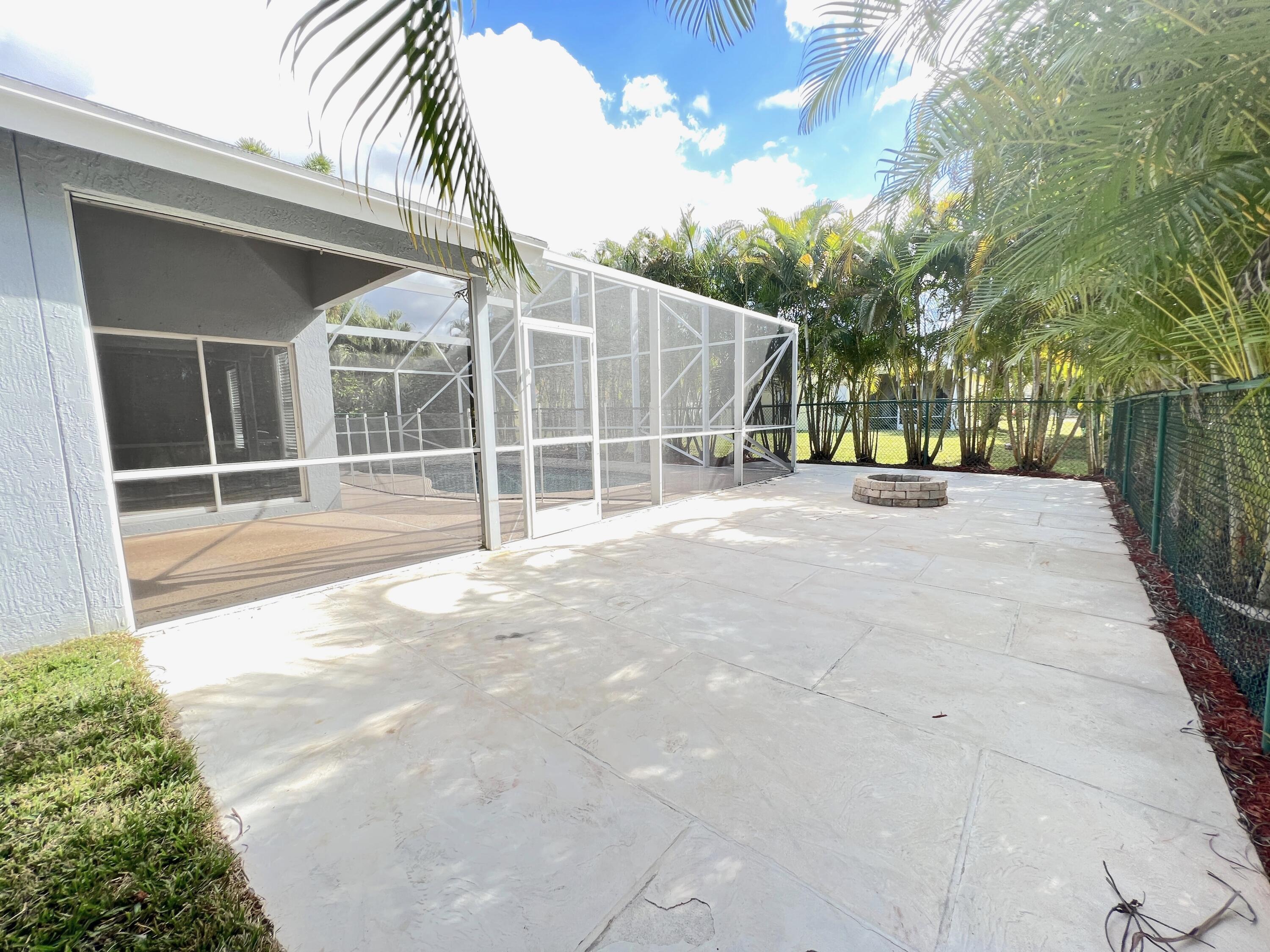 2464 Southwest Omega Way Stuart, FL 34997 - Photo 31 of 70 Back Patio grill & Fire pit area