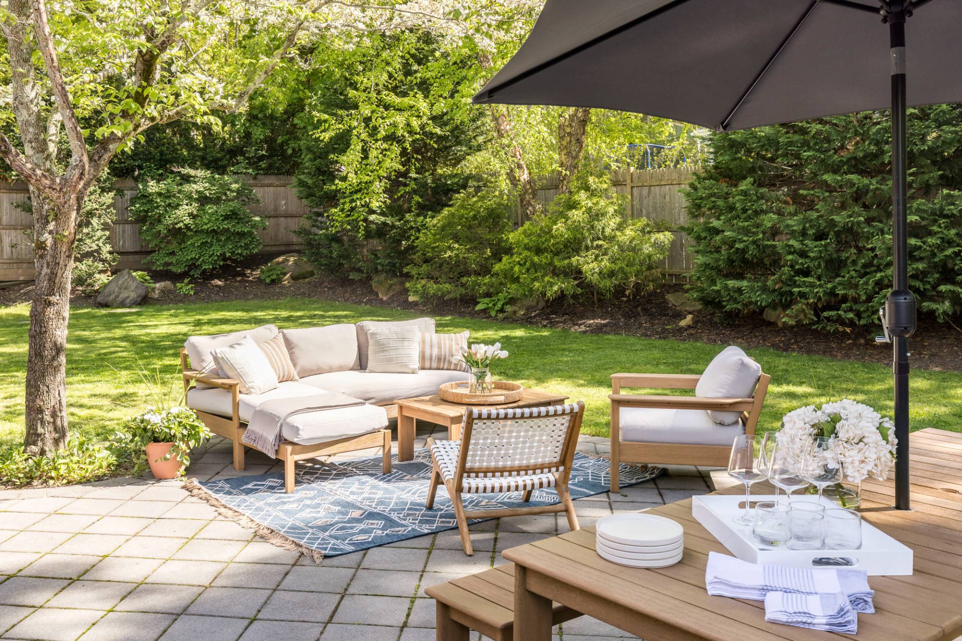 40 Ridge Road West Sag Harbor, NY 11963 - Photo 2 of 27 a view of a patio with lawn chairs under an umbrella