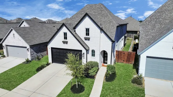 a front view of house with a garden