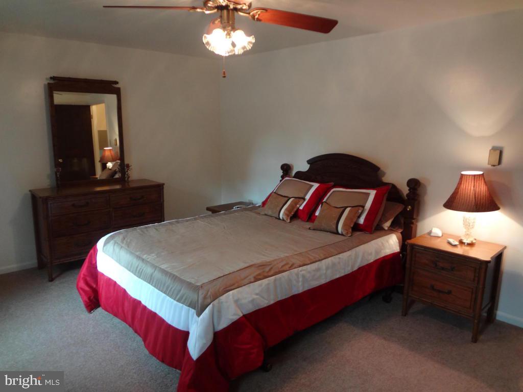 116 Winter Hill Road Lititz, PA 17543 - Photo 8 of 30 a bedroom with a bed and a lamp on dresser