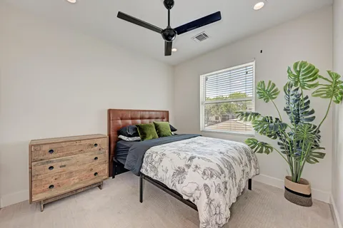 a bedroom with bed and a window