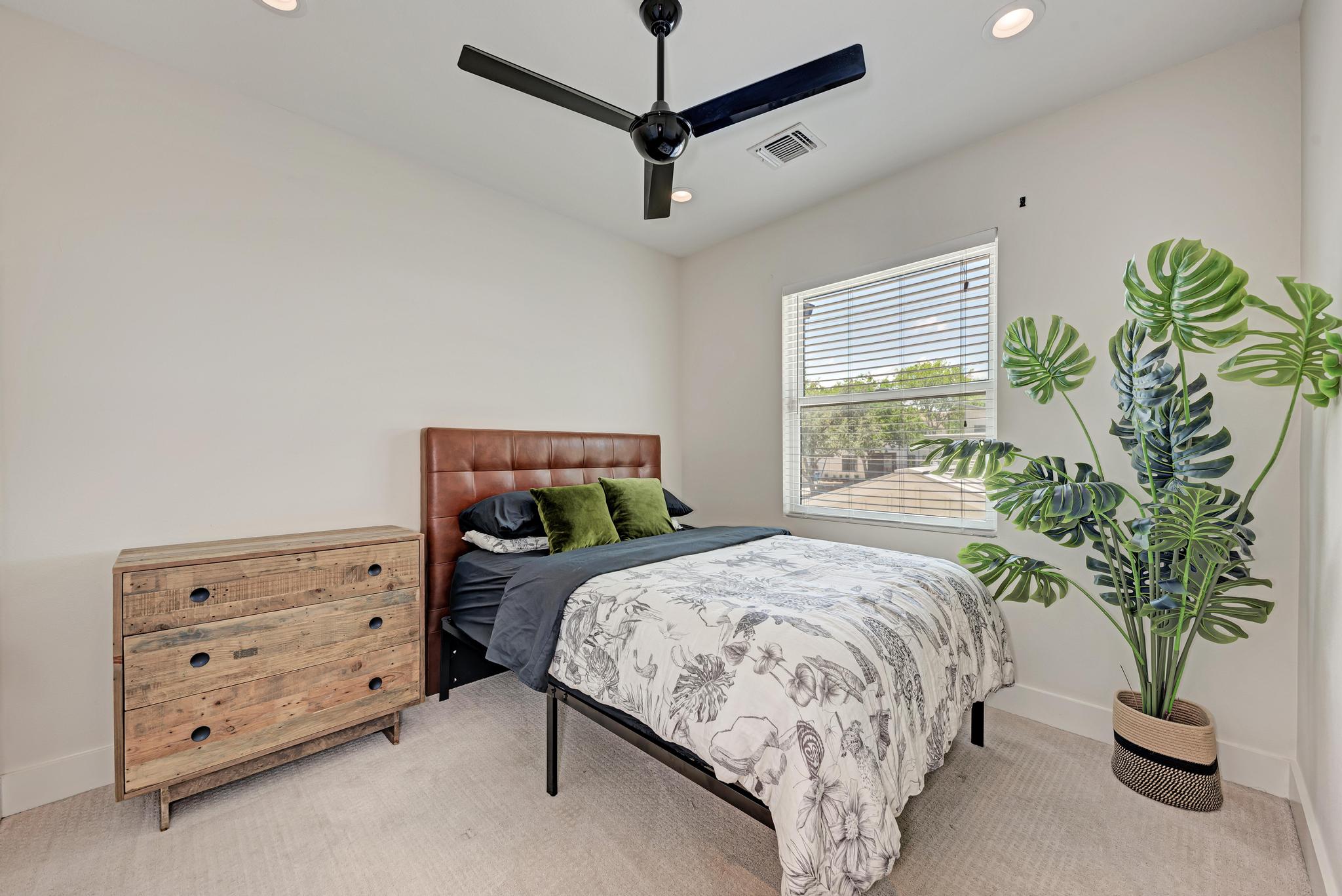 918 Cardinal Lane, Unit A Austin, TX 78704 - Photo 23 of 40 The secondary bedrooms feature comfortable carpeting, modern fans, and excellent closet strorage.