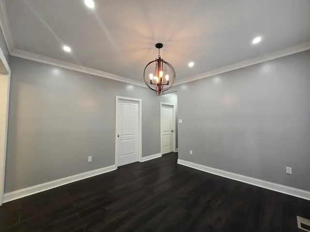 a view of wooden floor and chandelier in a room