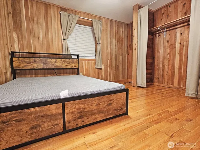 a view of wooden floor and closet in a kitchen