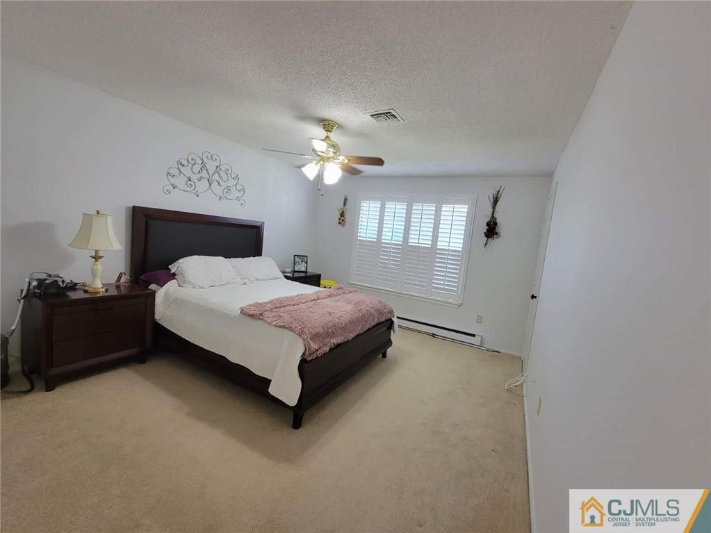35 Haddon Road, Unit A Monroe Township, NJ 08831 - Photo 15 of 18 a bedroom with a bed and a chandelier