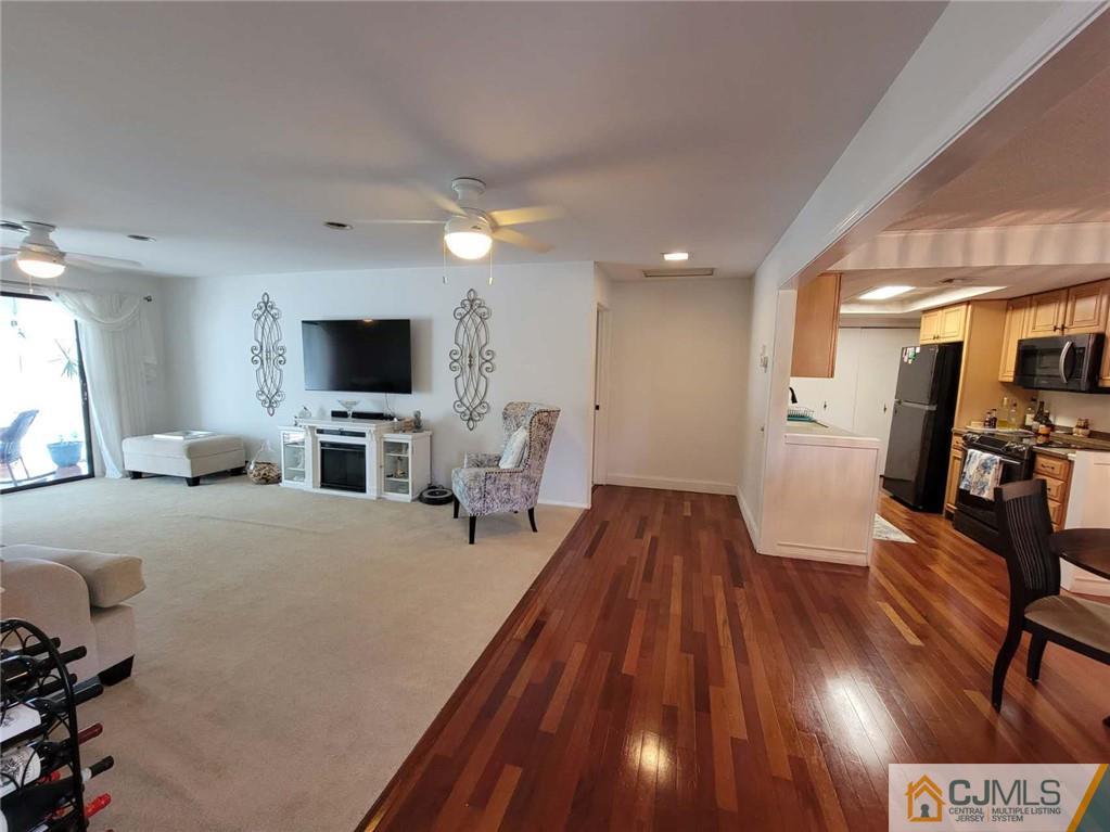 35 Haddon Road, Unit A Monroe Township, NJ 08831 - Photo 3 of 18 a living room with furniture and a flat screen tv