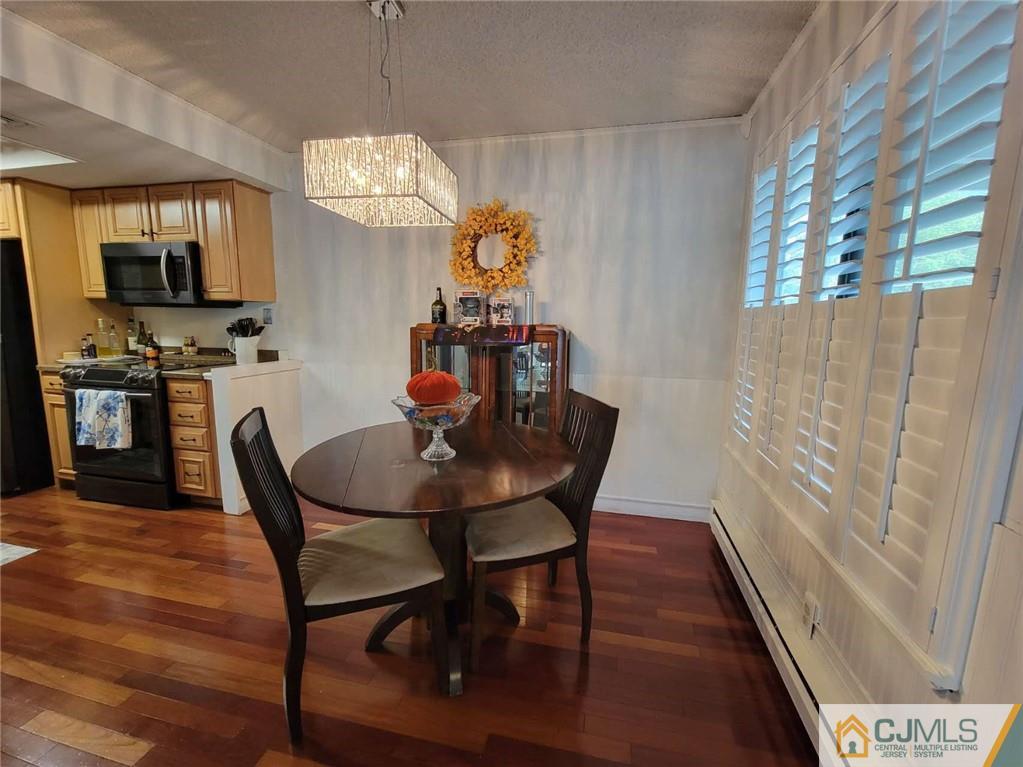 35 Haddon Road, Unit A Monroe Township, NJ 08831 - Photo 4 of 18 a view of a dining room with furniture and wooden floor