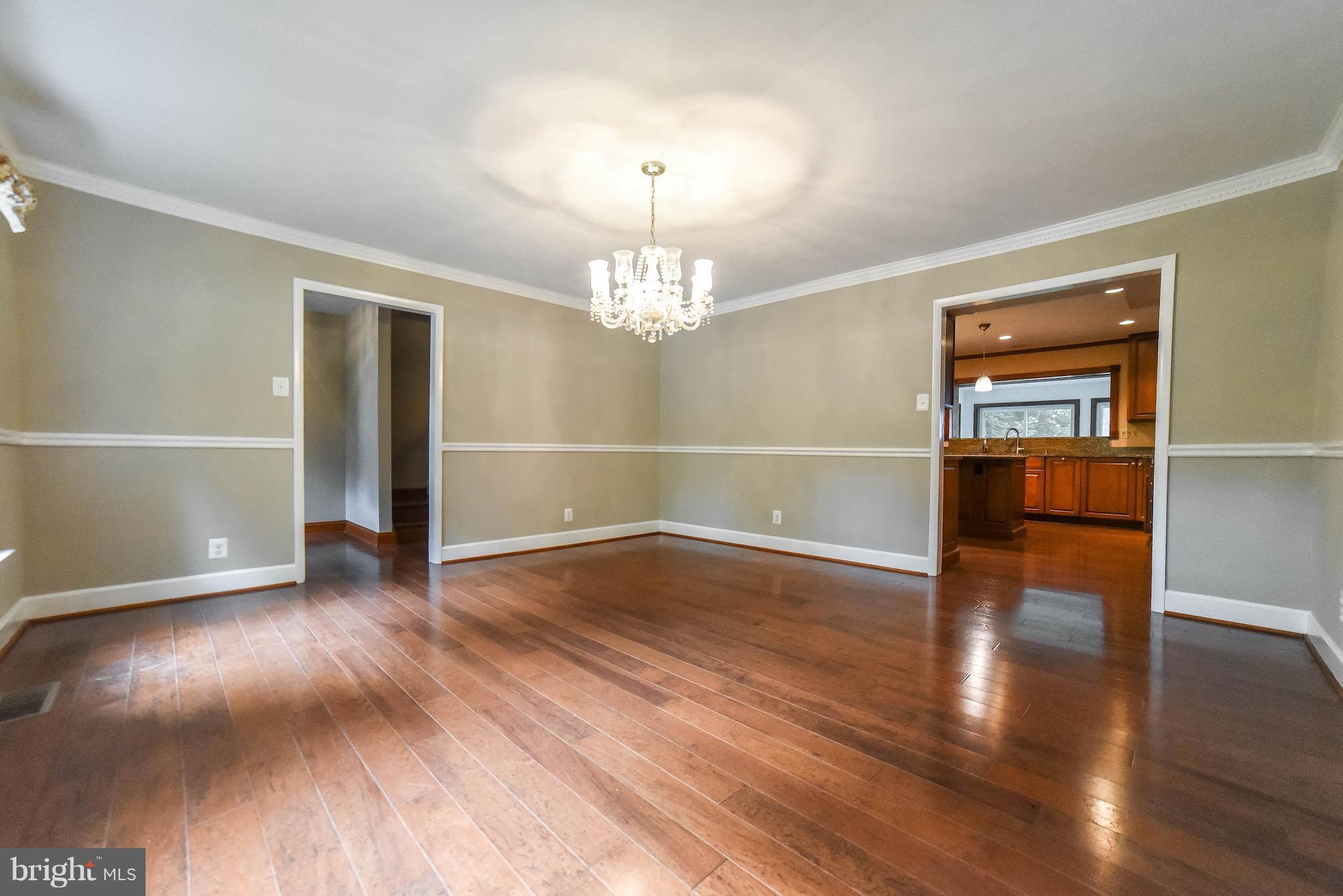 3540 Patuxent Road Huntingtown, MD 20639 - Photo 14 of 29 an empty room with wooden floor chandelier and windows