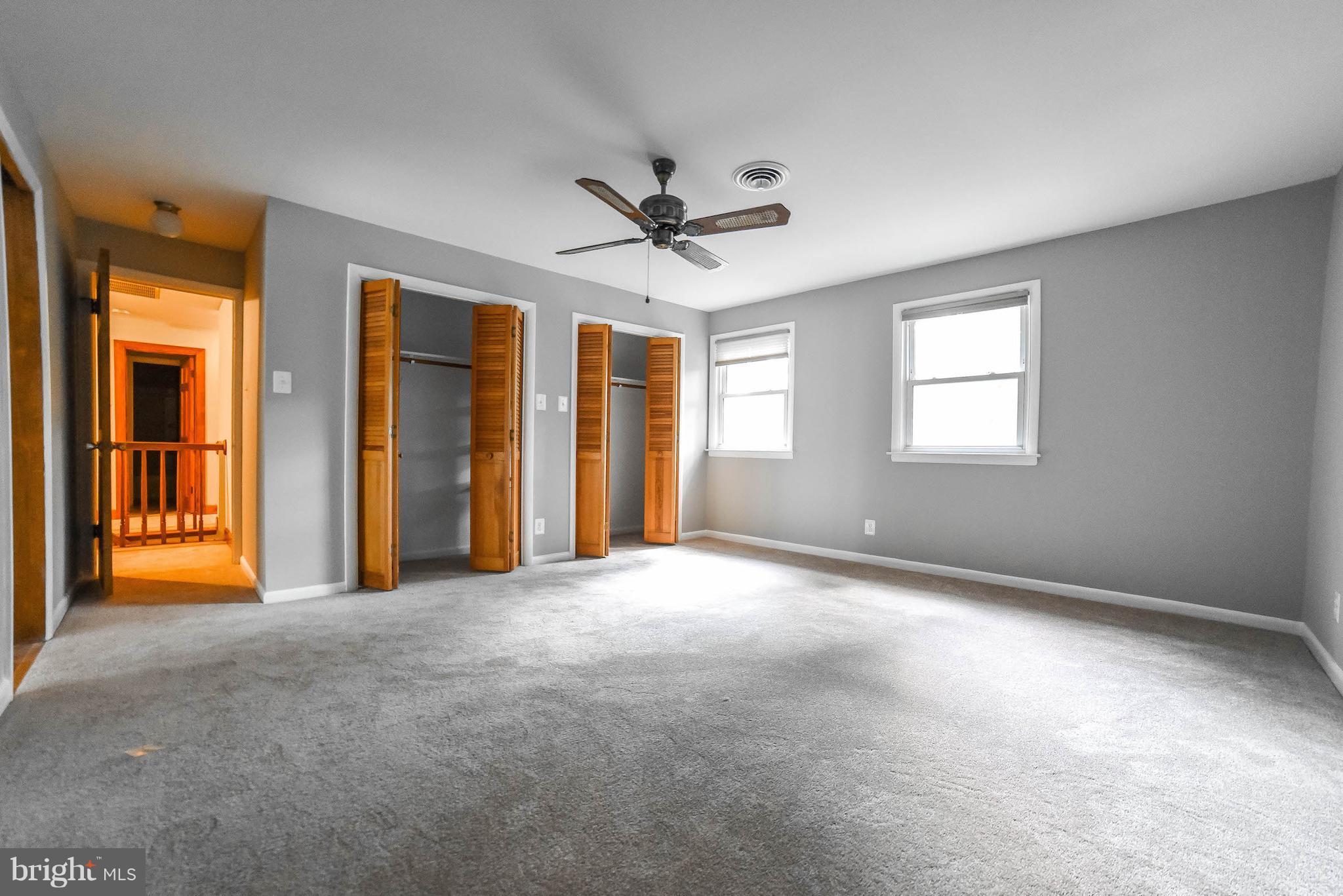 3540 Patuxent Road Huntingtown, MD 20639 - Photo 22 of 29 an empty room with chandelier fan and windows