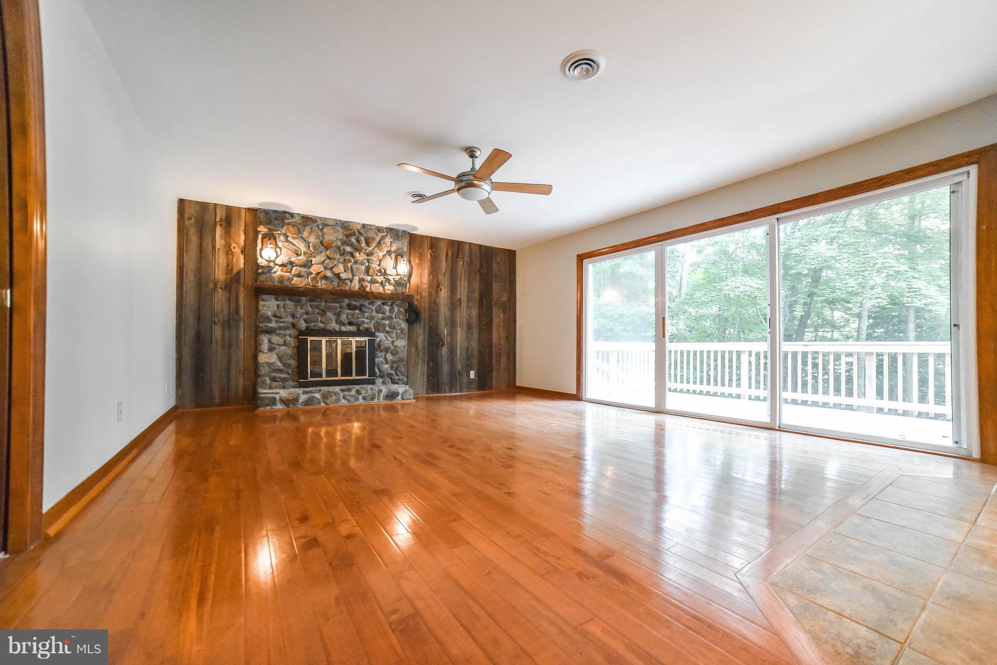 3540 Patuxent Road Huntingtown, MD 20639 - Photo 5 of 29 a view of an empty room with a window and wooden floor