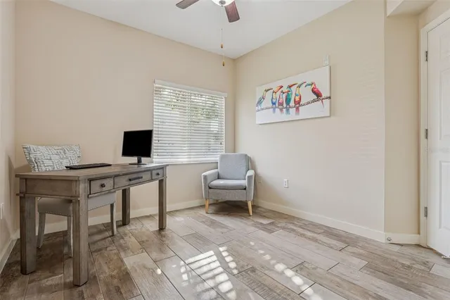 a view of a workspace with furniture and a window