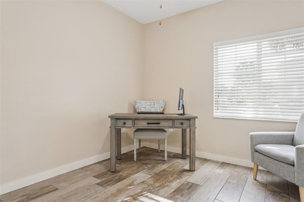 1231 Godavari Way, Unit 101 Wesley Chapel, FL 33543 - Photo 15 of 36 a view of a workspace with furniture and a window