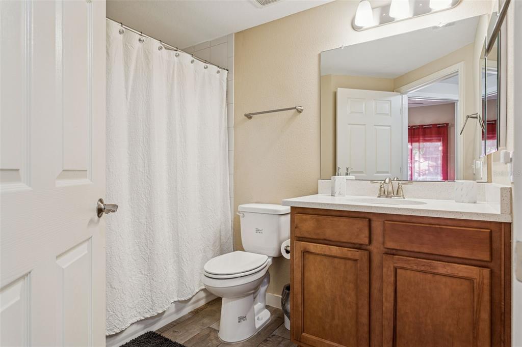 1231 Godavari Way, Unit 101 Wesley Chapel, FL 33543 - Photo 16 of 36 a bathroom with a sink a toilet and shower