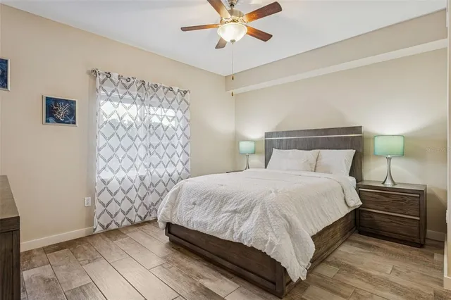 a bedroom with a bed and ceiling fan