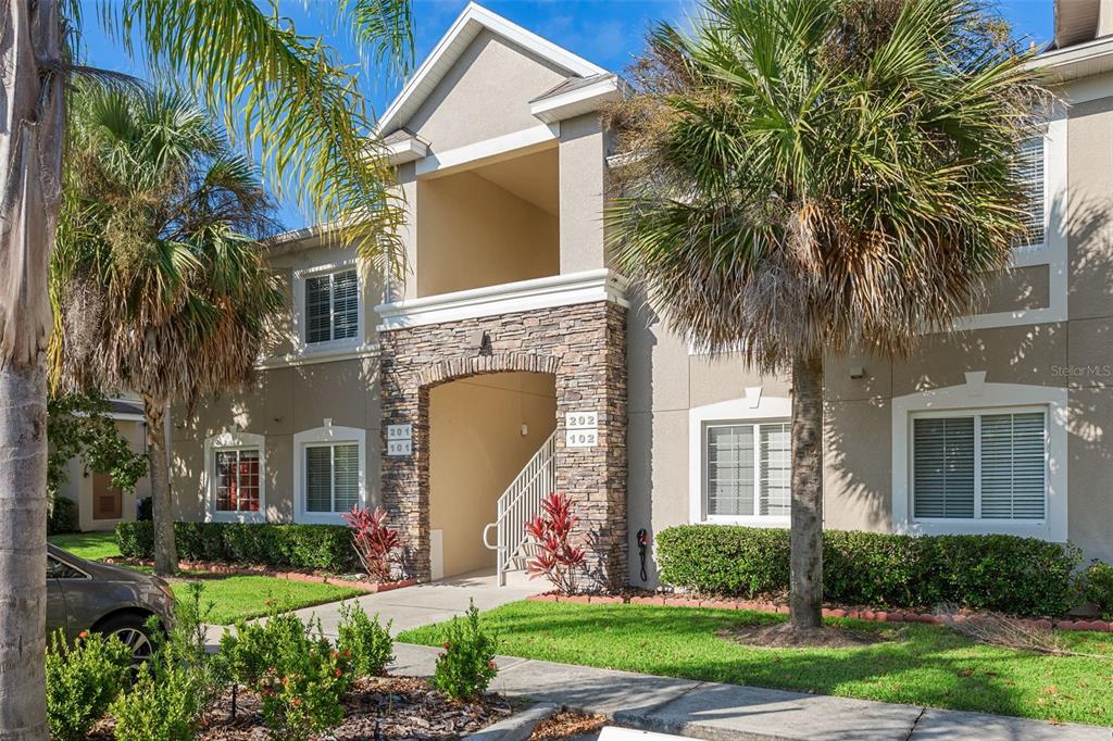 1231 Godavari Way, Unit 101 Wesley Chapel, FL 33543 - Photo 2 of 36 a front view of a house with yard and green space